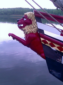 Before and after photos of the lion rampant figurehead.