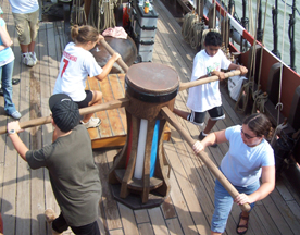 Students work the capstan.