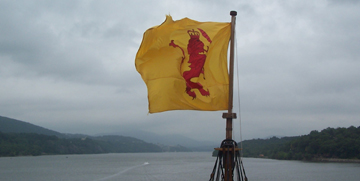 The lion rampant flag flutters in the wind.