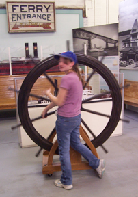 Joli spins a ship's wheel at the Hudson River Maritime Museum.
