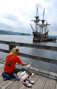 Ms. Crone paints the Half Moon from a dock farther upriver.