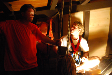 Patrick and Ewout chat in the foc's'le in the glow of the anchor light.