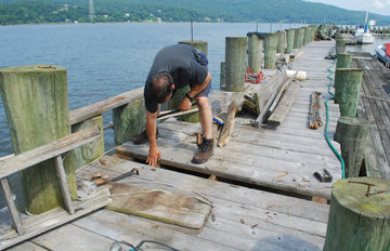 Peter replaces a plank on the King Marine dock.