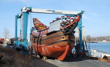 The travelift prepares to move the Half Moon from its month-long perch alongside the Hudson River.
