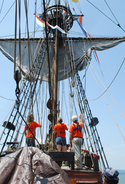The foremast team sets the fore course.