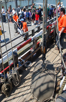 Students at the Newburgh dock use a block-and-tackle system to lift heavy cargo off the deck.