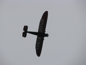 A biplane from the Rhinebeck Aerodrome swoops overhead.