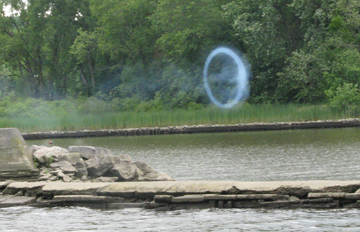 A smoke ring hangs in the air.