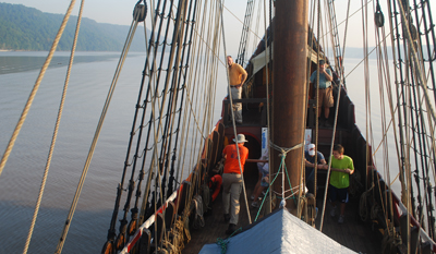 The capstan crew works as the ship floats before the Palisades.